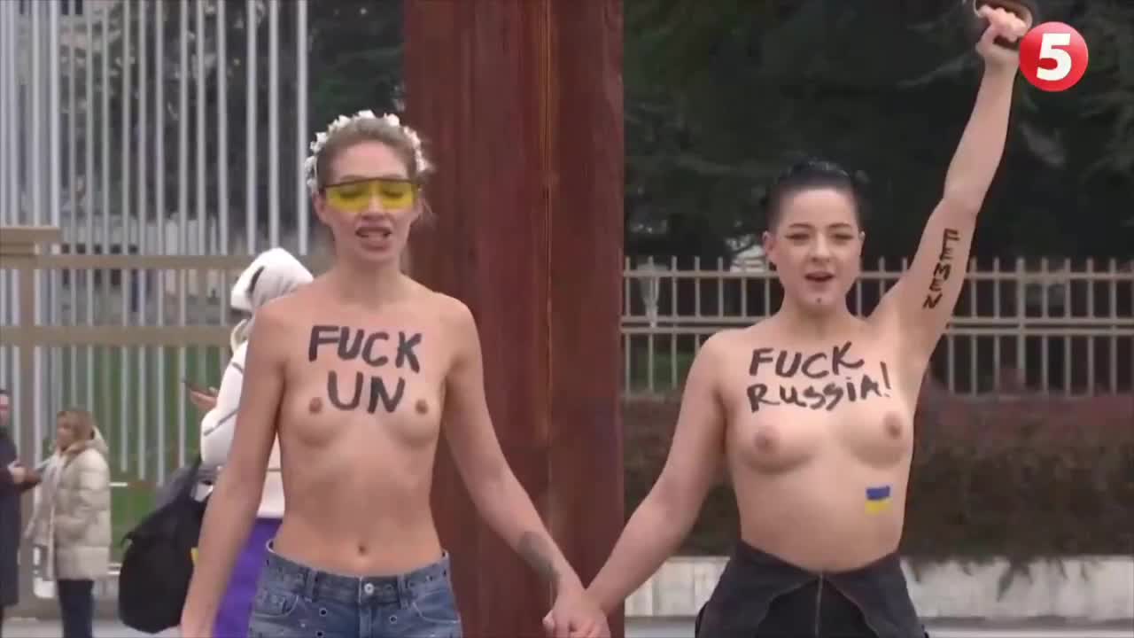 乌克兰女权示威者赤裸上身举行反俄集会，在联合国欧洲总部外用电锯损坏“破椅子”纪念碑雕塑.MP4
